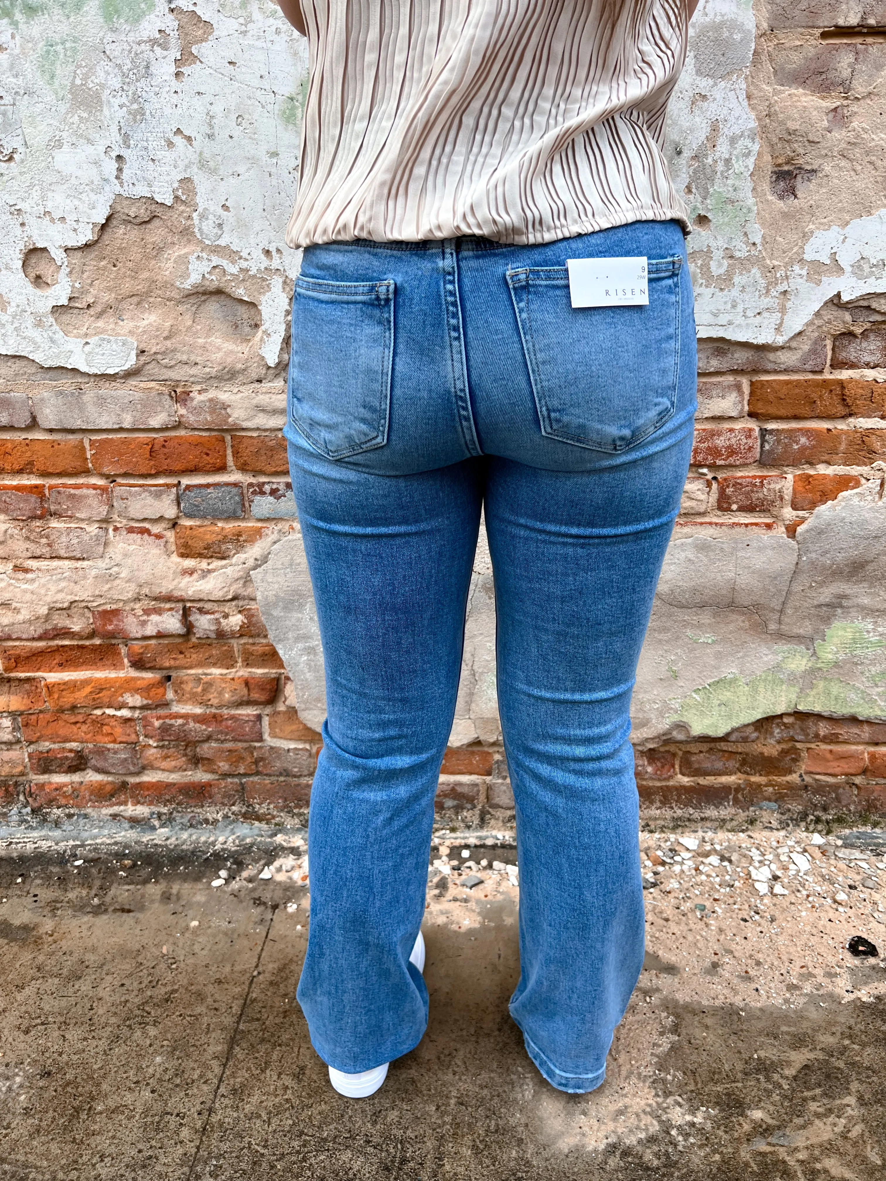 Alaia High Rise Button Down Boot Cut Jeans